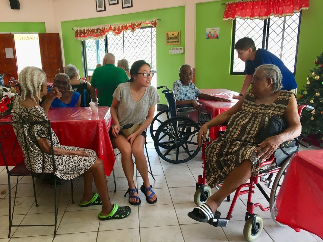 Students with the elderly in St. Lucia