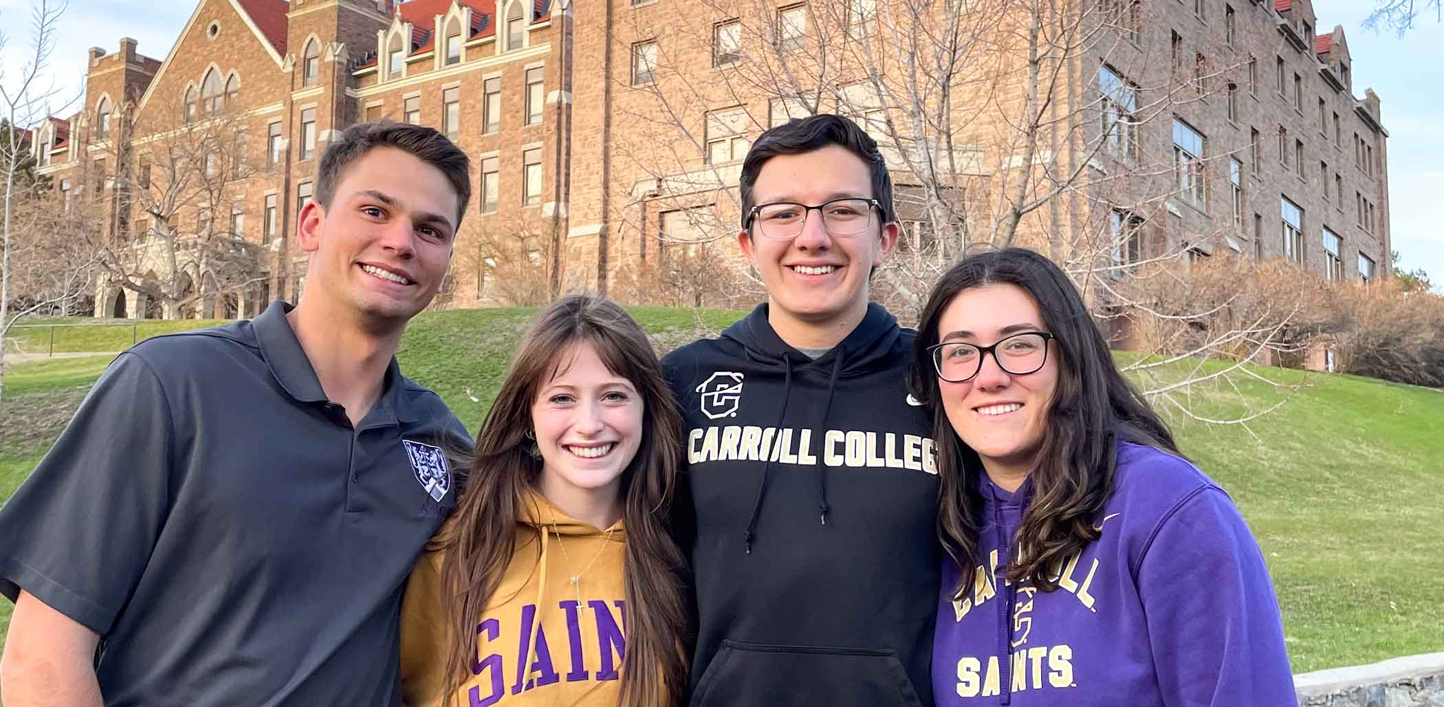Four Carroll student in front of St. Charles