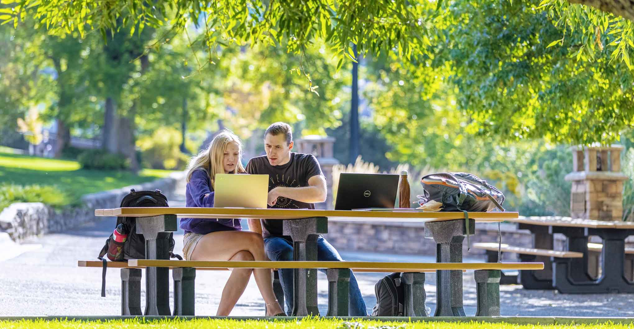 Two Students Studying Outside at a Picnic Table