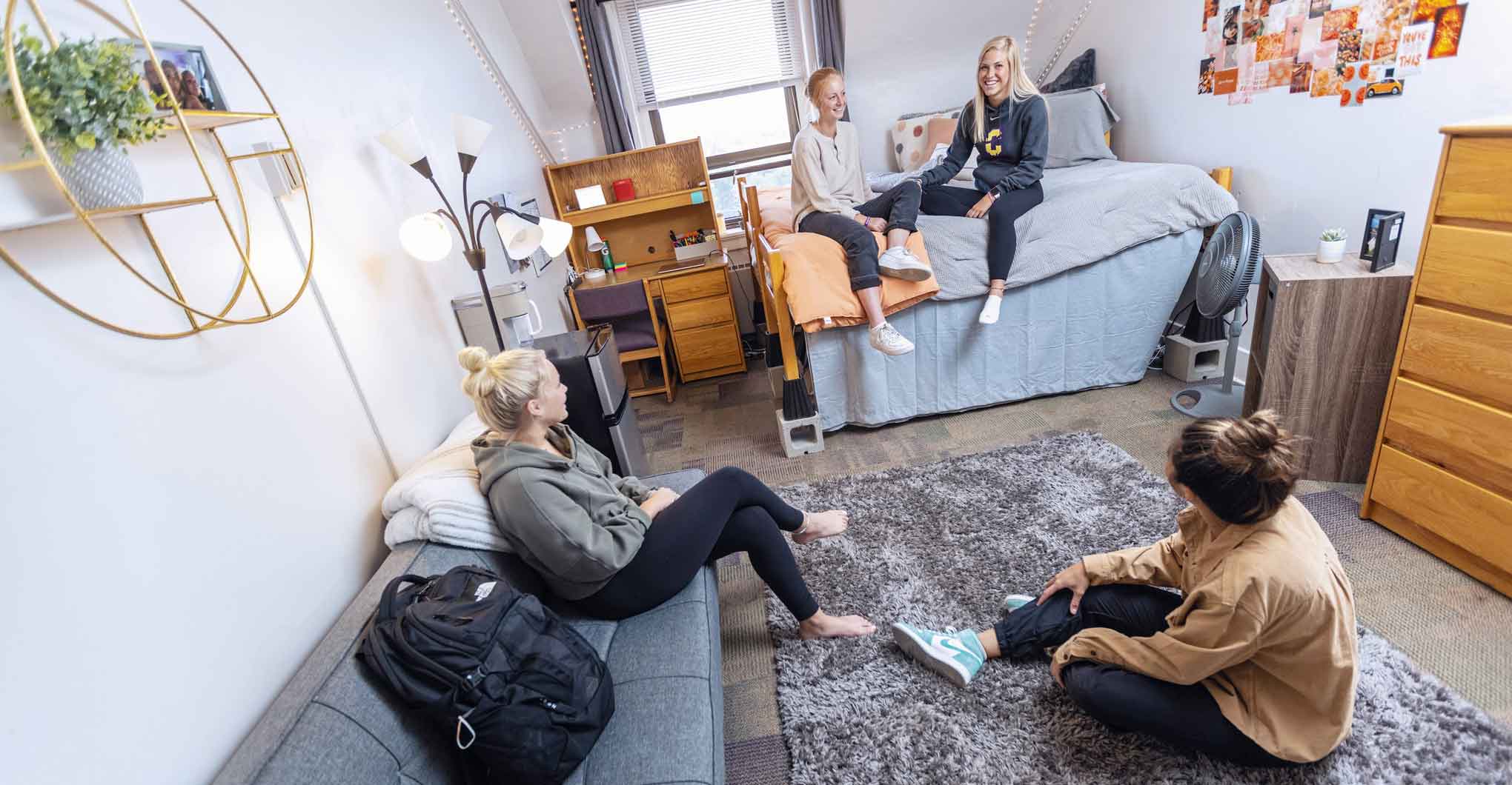 Four female students in residence hall room