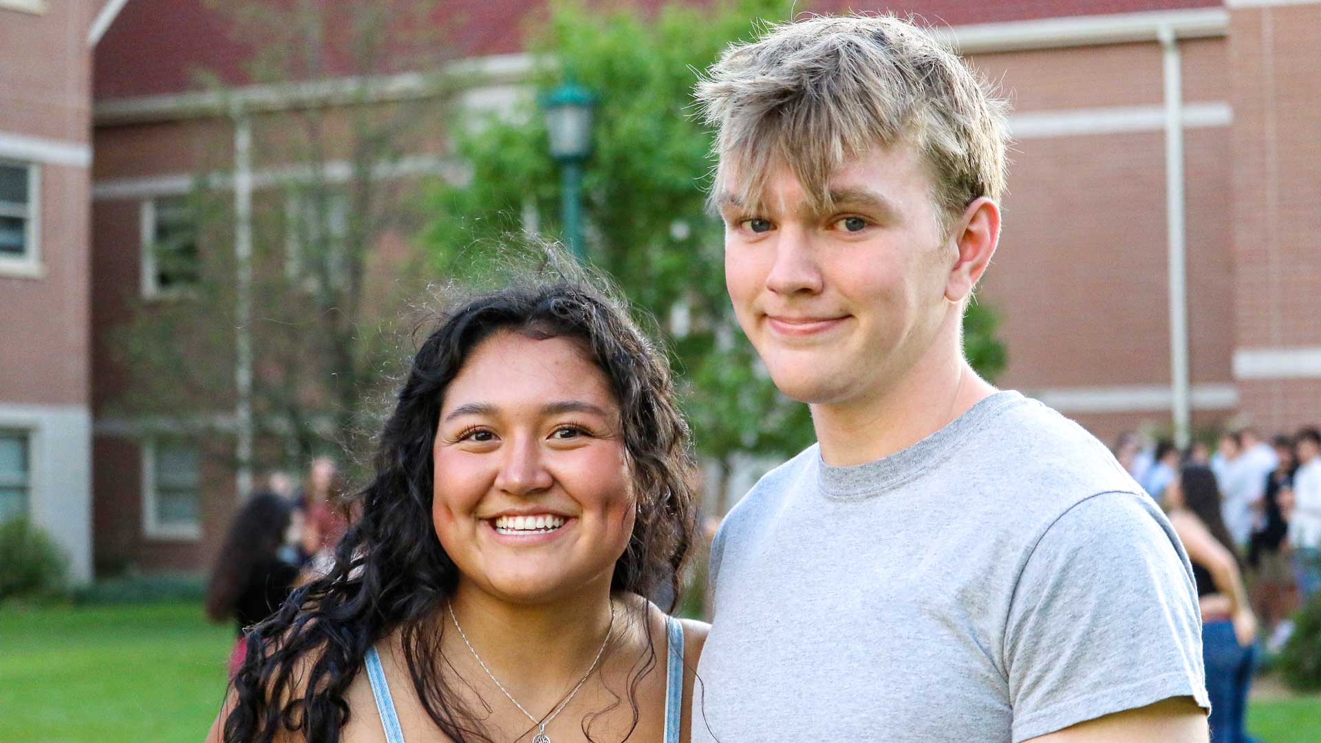 Two students outside smiling