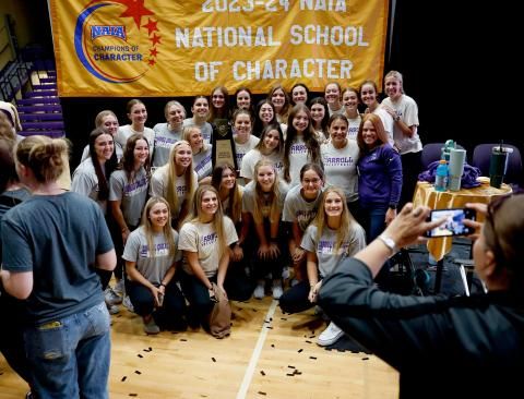 Volleyball team with NAIA Banner